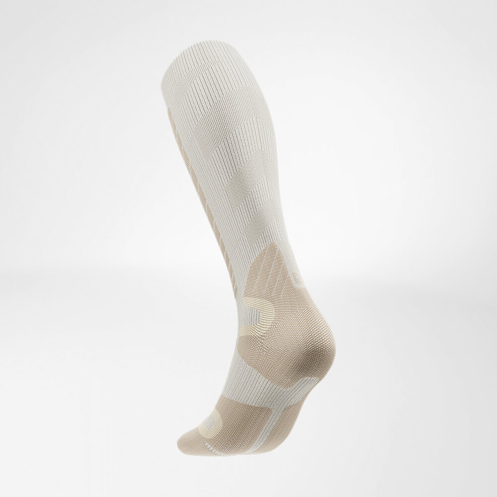 Side view of the inside of the beige sports sock for Alpine skiing with merino wool