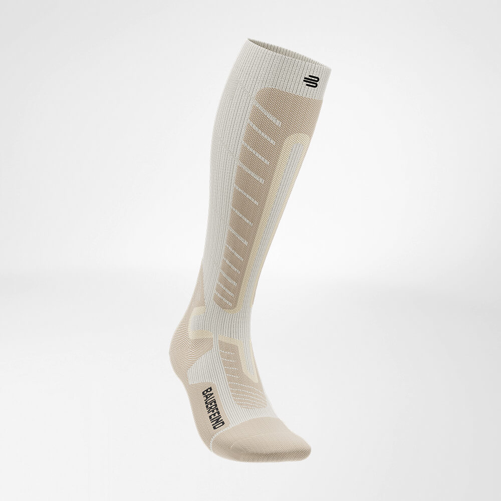 Side front view of the beige sports sock for alpine skiing with merino wool