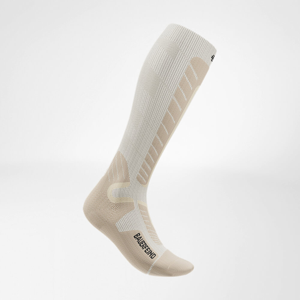 Side view of the beige sports socks for alpine skiing with merino wool