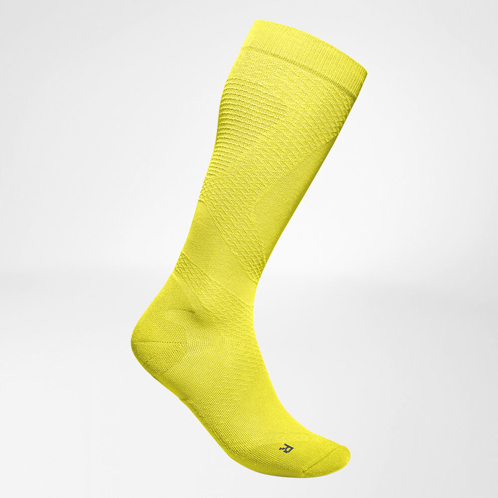 Lateral complete view of the yellow airy knitted compression socks to run