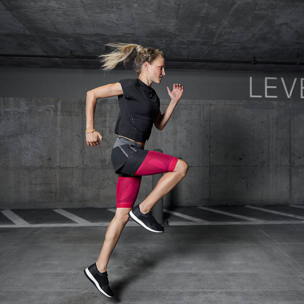 Woman runs through an underground car park with pink thighs and does sports
