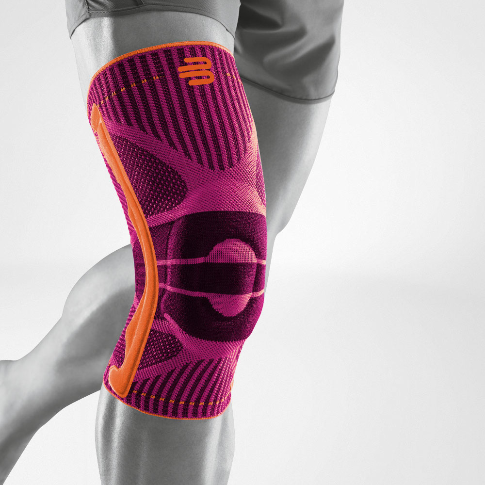 Complete view of a pink knee band for sport on the stylized gray leg