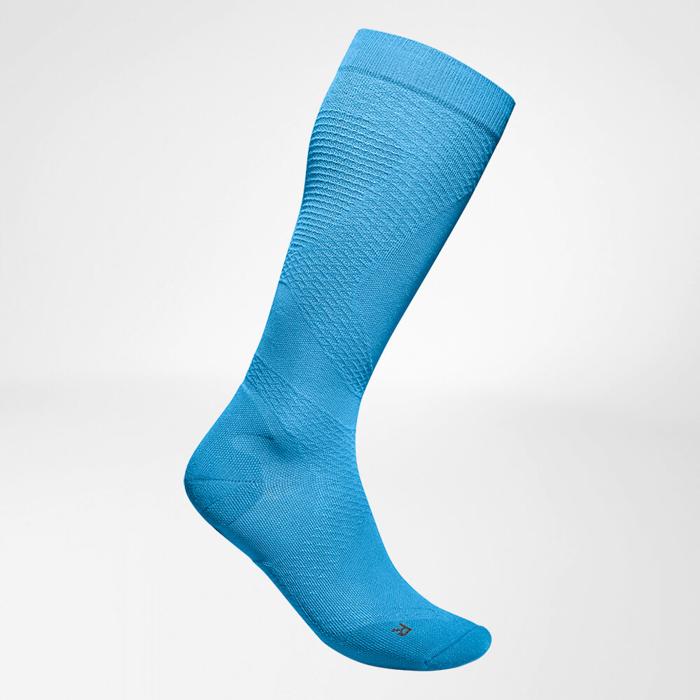 Lateral complete view of the blue airy, knitted compression socks to run
