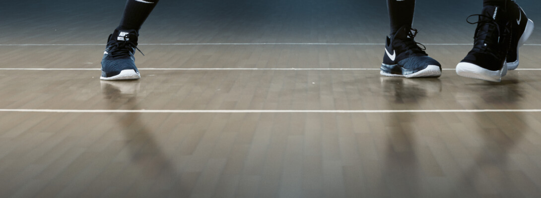 Ankle bandage Dirk Nowitzki in basketball View of the floor of a basketball hall and the feet of two players
