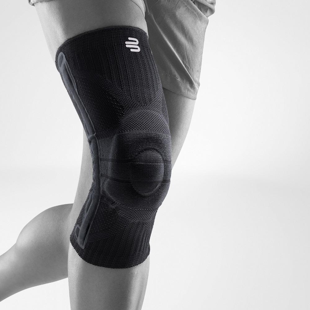 Complete view of a black knee band for sport on the stylized gray leg