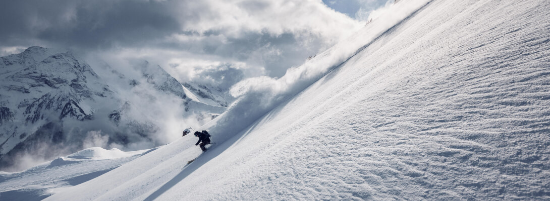 Merino ski socks for alpine skiing Skier on a steep piste during downhill skiing